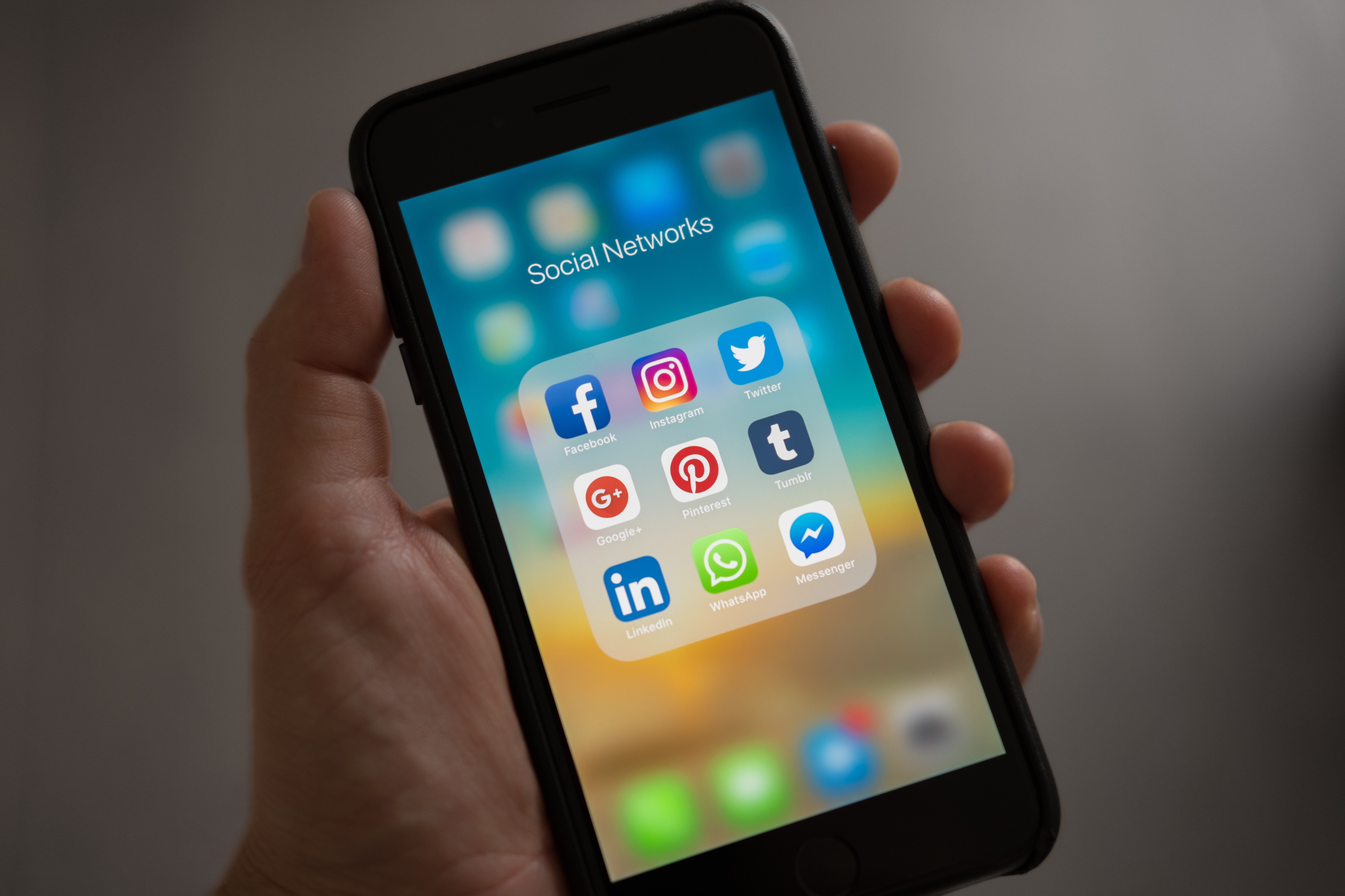 social-media Phone with social media apps on display. Apps showing include facebook, instagram, twitter, Google+, Pinterest, Tumblr, linkedin, whatsapp and facebook messenger.